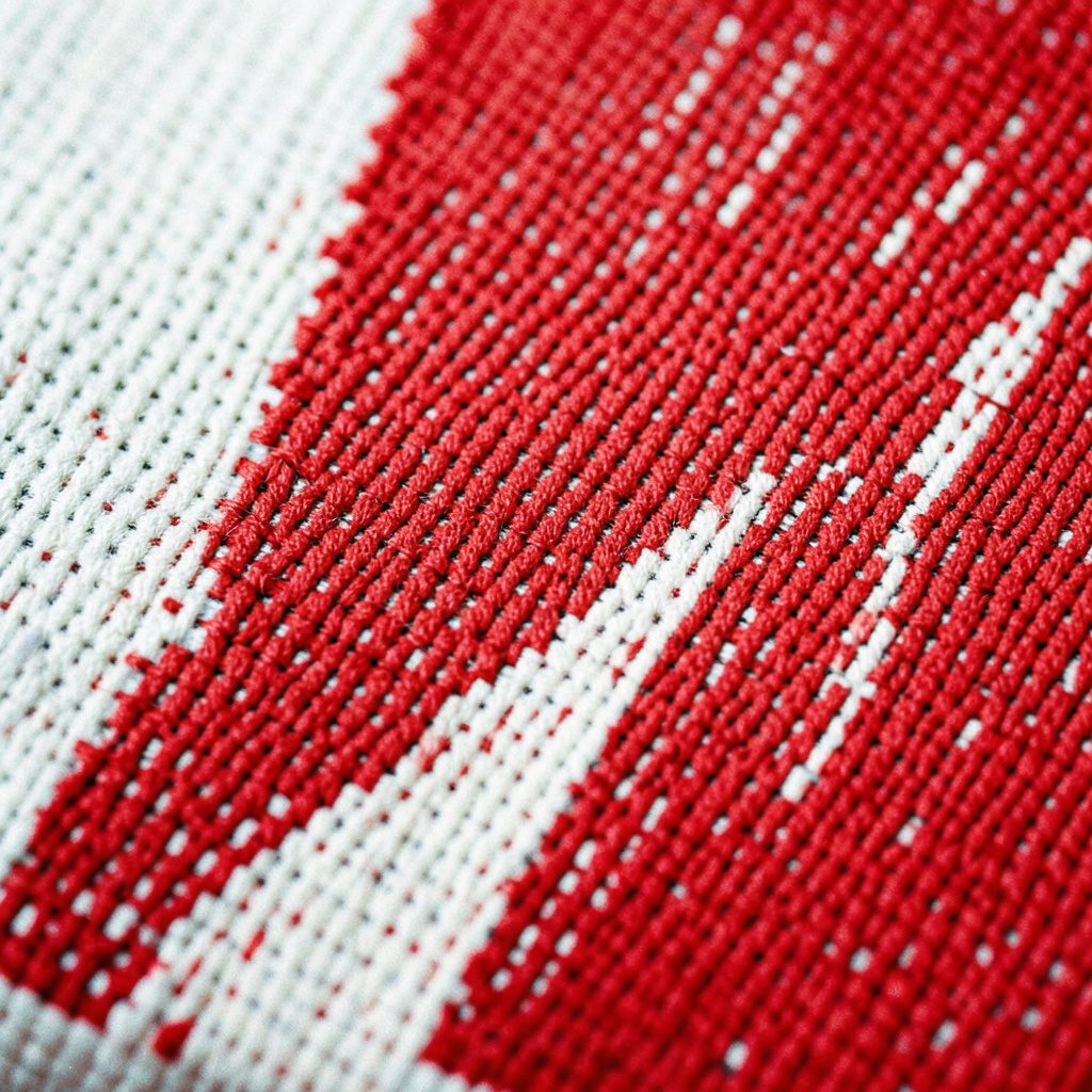 A close-up documentary photograph of needlepoint fabric showing several diagonal stitch samples in warm cream, rust, and olive threads against a natural linen background.